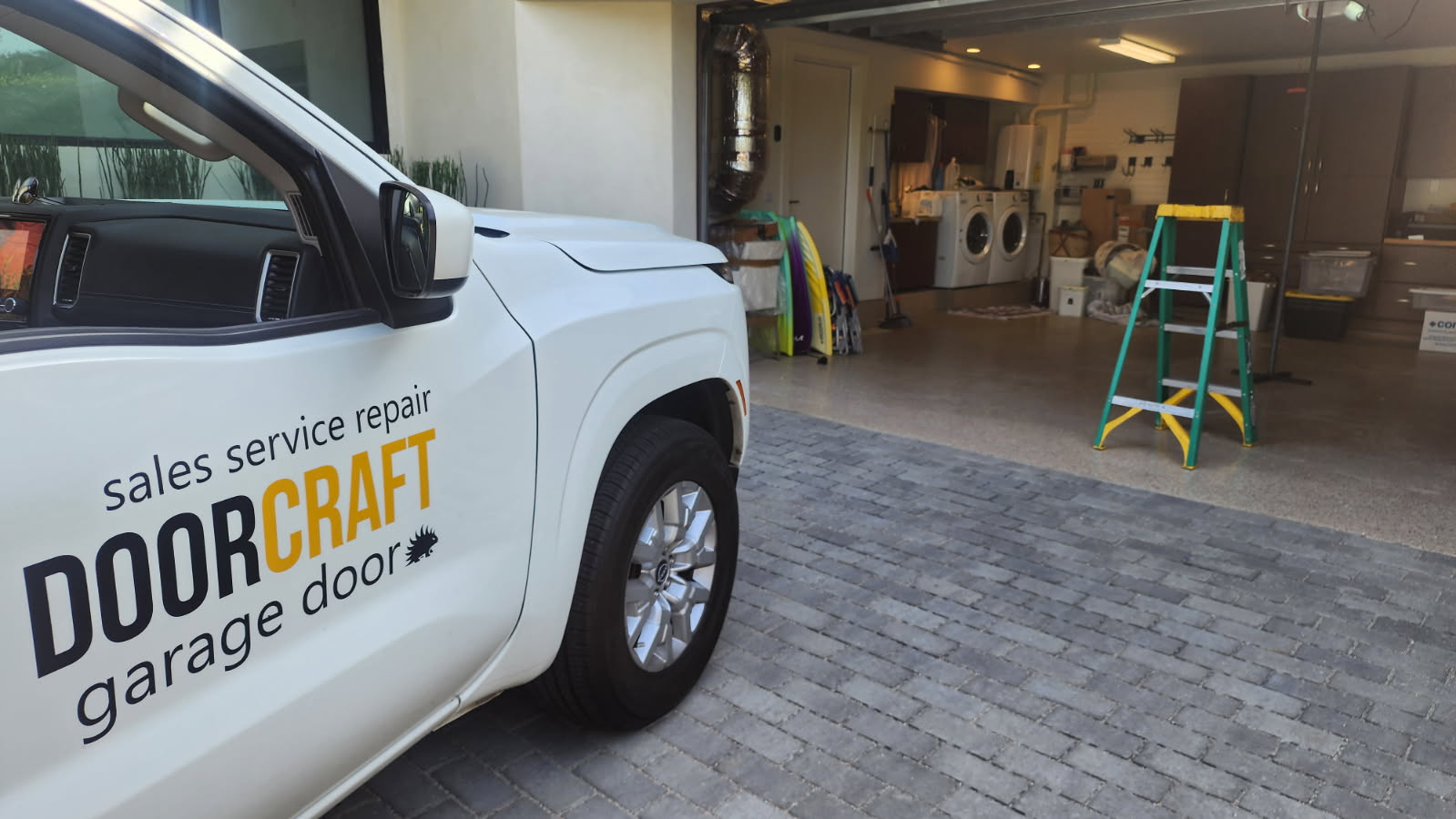 Doorcraft SVC branded service truck at a residential garage in San Diego County