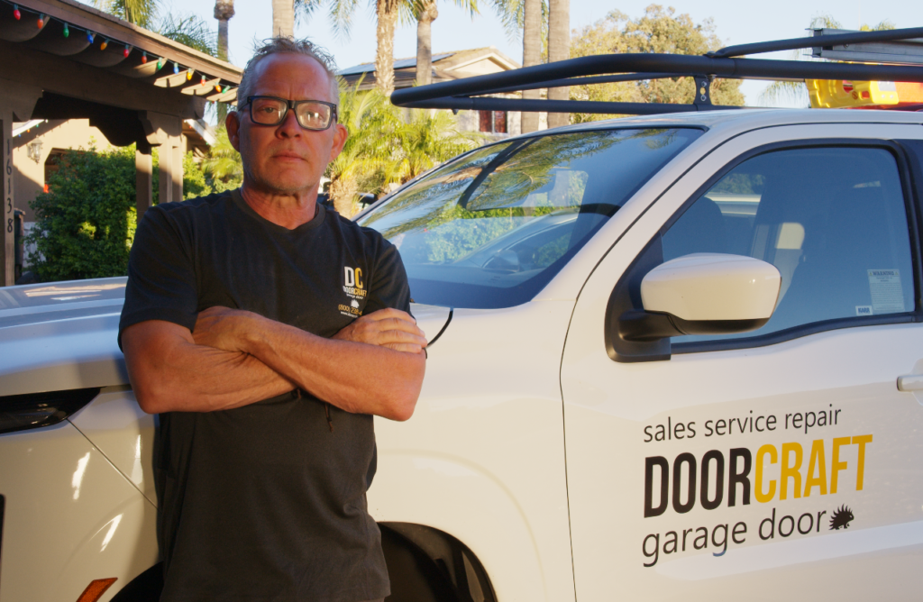 John, owner of Doorcraft SVC, beside the branded service truck